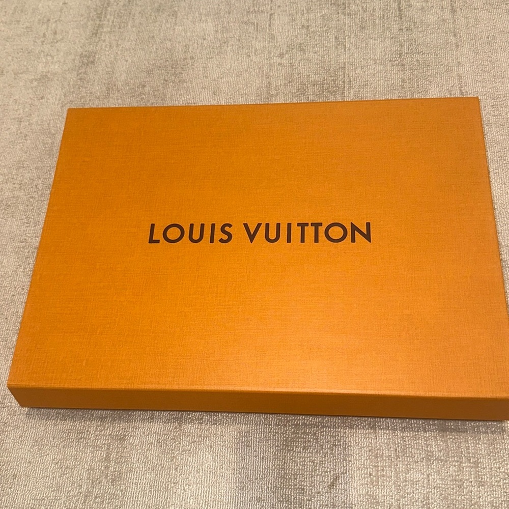 Louis Vuitton box, ribbon, and card.